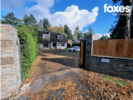 A detached house occupying a large plot with planning permission for substantial extension